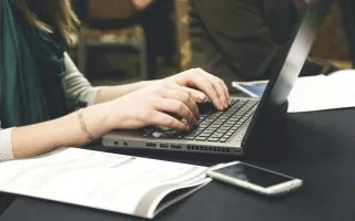Free woman's hands typing on laptop